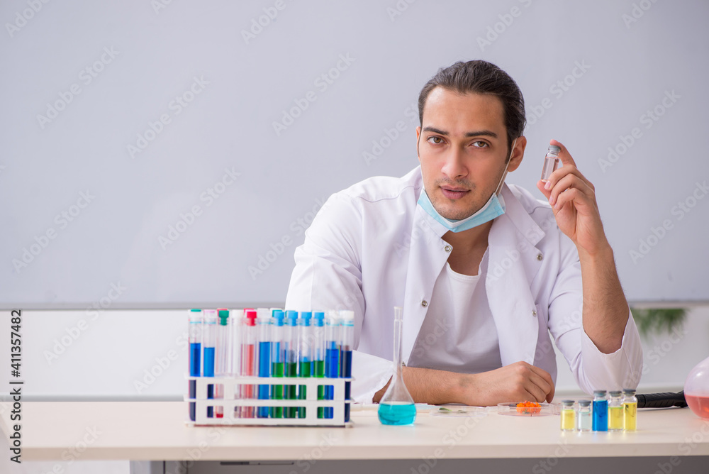 Young male chemist working in the lab Young male chemist working in the lab