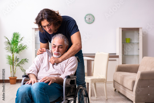 Old man in wheel-chair and young bad caregiver indoors © Elnur