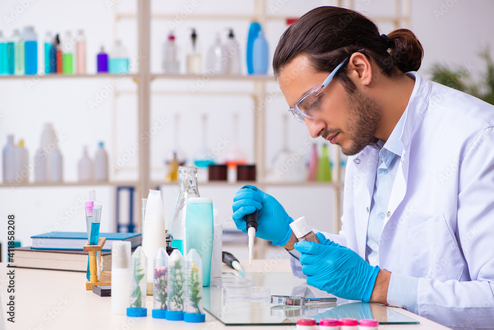 Young male chemist working in the lab Young male chemist working in the lab
