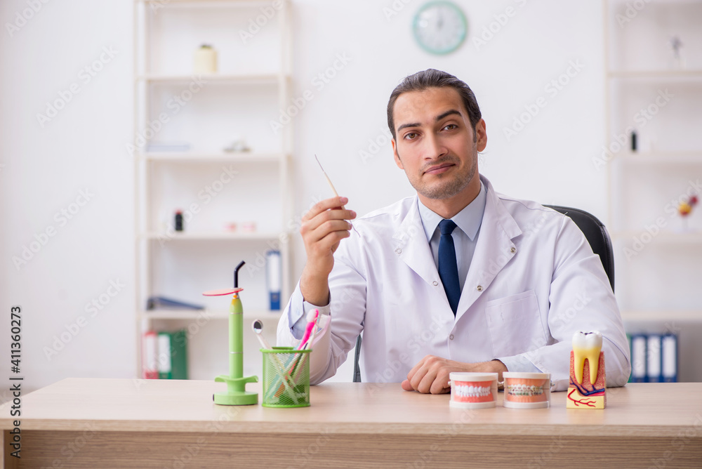 Young male doctor stomatologist working in the clinic Young male doctor stomatologist working in the clinic