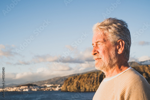 close up and portrait of sad and pensive man looking at the sea in the beach - upset people lifestyle concept