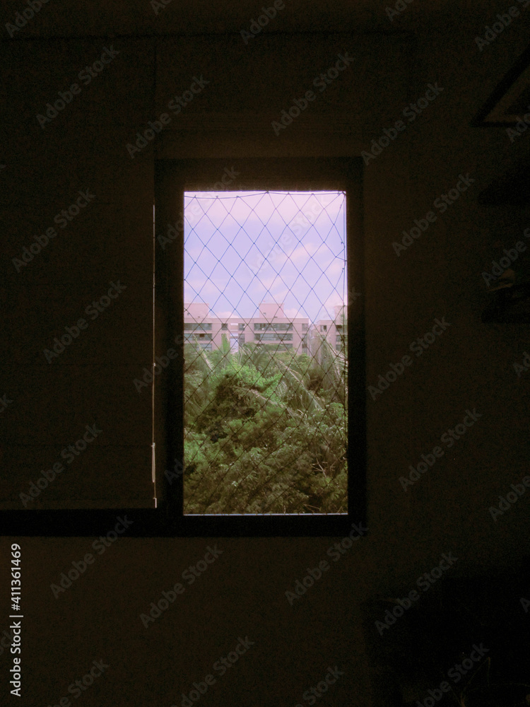 blue sky behind nature and buildings, seen from a window blue sky behind nature and buildings, seen from a window