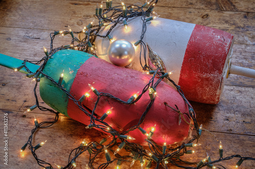 Colorful Maine Red green and white lobster float buoys surrounded by Christmas holiday lights photo