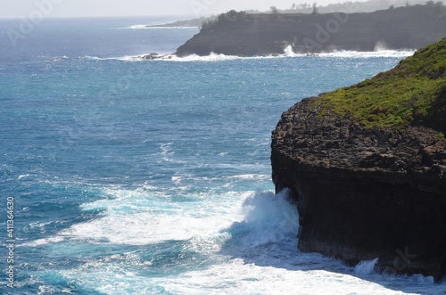 Beautiful view of the Pacific ocean, crashing its large waves against the cliffs and rocks in Hawaii