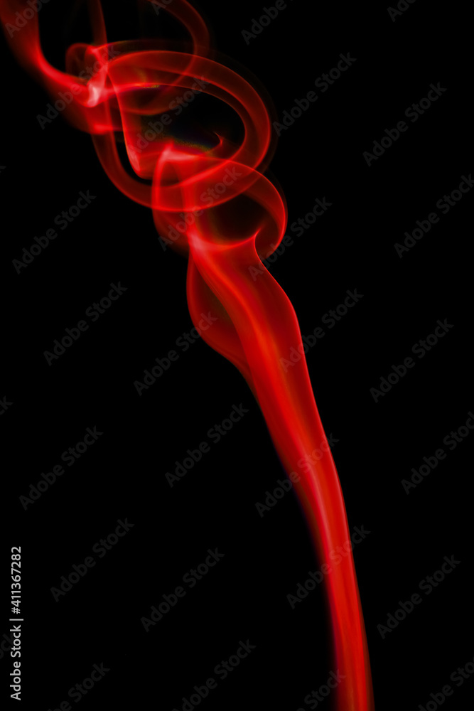 Obraz premium swirling movement of red smoke group, abstract line Isolated on black background