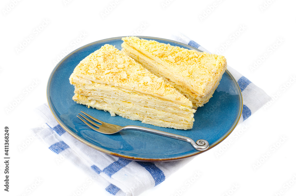 Plate with slice of homemade puff pastry with cream. Studio Photo
