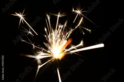 Bright sparks in total darkness. Closeup.