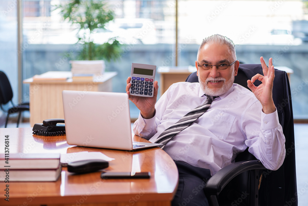 Old businessman employee working in the office Old businessman employee working in the office