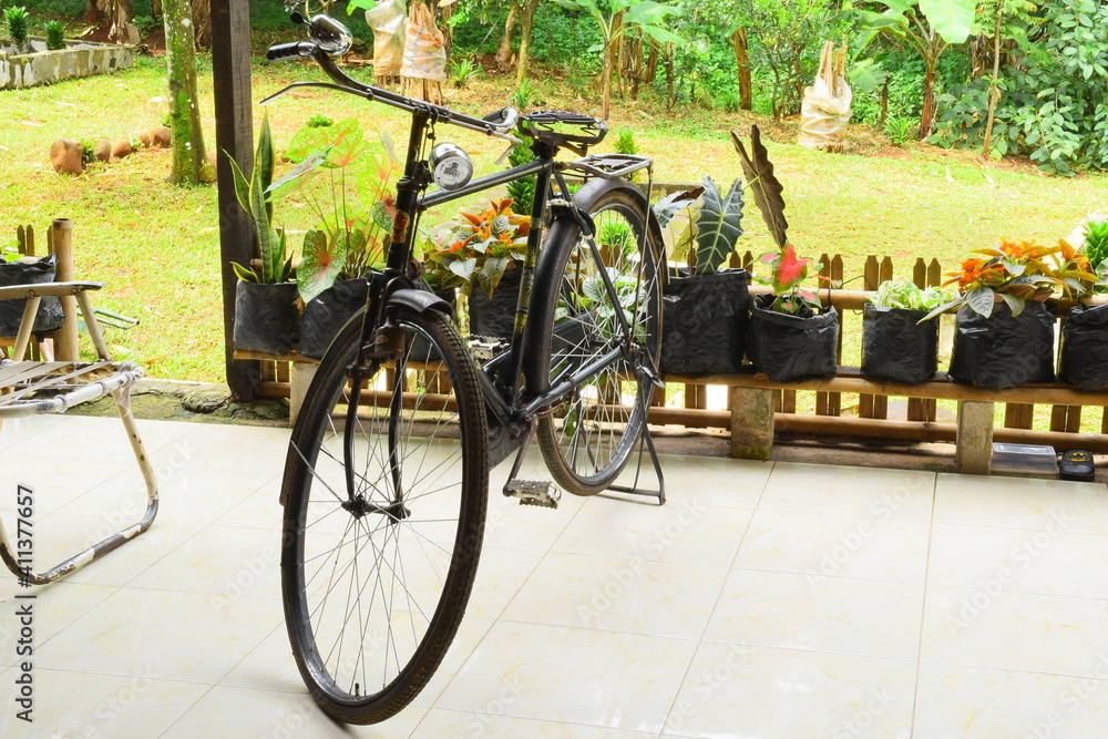 Old bicycle with a porch in the background. Retro bike or onthel bike.