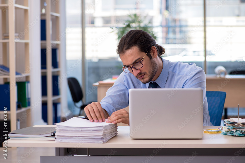 Young male accountant working in the office Young male accountant working in the office
