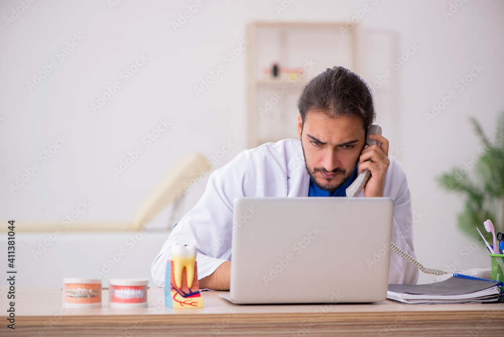 Young male odontologist in telemedicine concept Young male odontologist in telemedicine concept