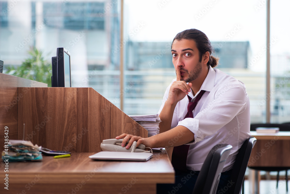 Young male employee in industrial espionage concept Young male employee in industrial espionage concept