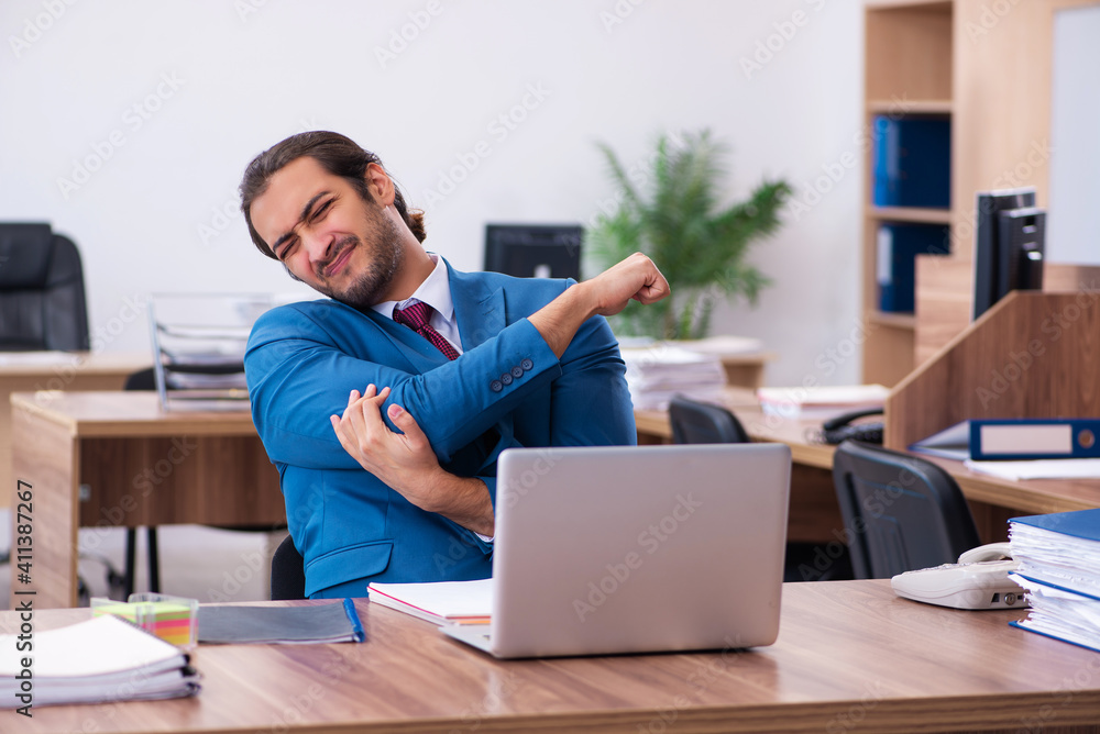 Young male employee working at workplace Young male employee working at workplace
