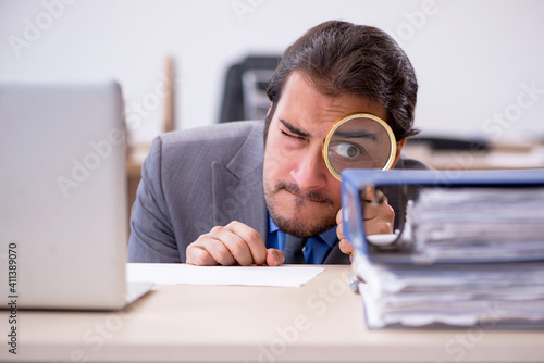 Photography Young male employee in industrial espionage concept