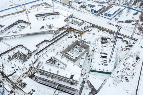 aerial view of city construction site with working cranes in winter time © Mr Twister