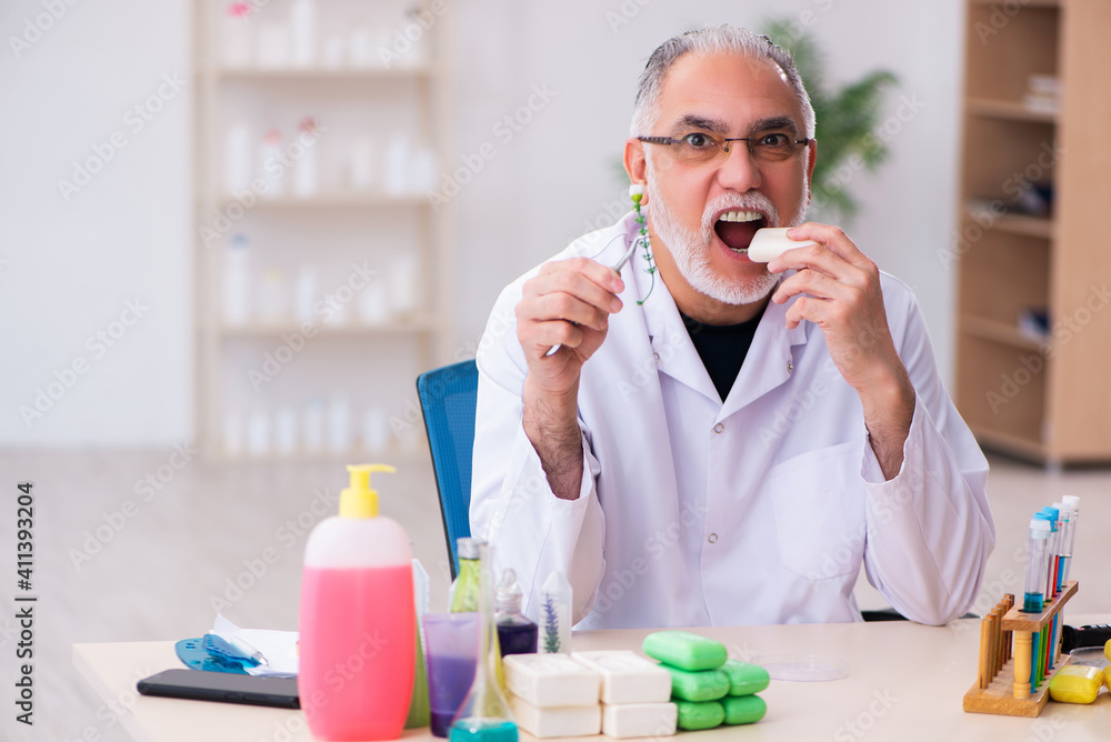 Old male chemist testing soap in the lab Old male chemist testing soap in the lab