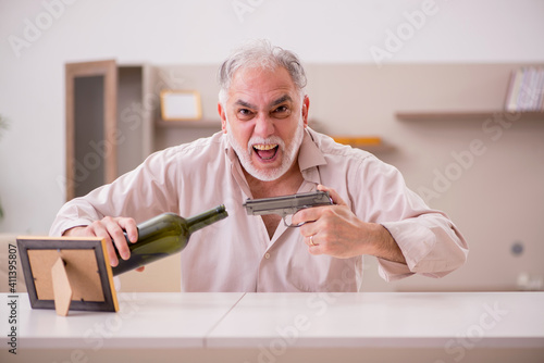 Tablou pe pânză Old male alcoholic widower committing suicide at home