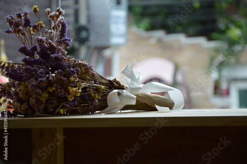 A photo of a bouquet of dried flowers of various colors placed on the table as a beautiful background image.