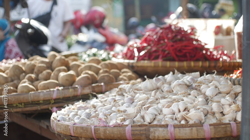 garlic, chilies, and potatoes photographed at a market in Indonesia in January 2021.