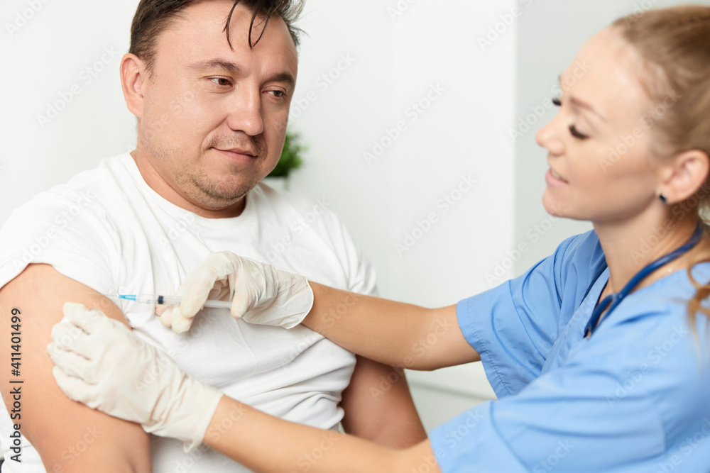 female doctor holding an injection to a patient vaccination