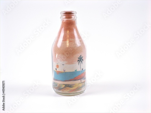 Bottle of beach art isolated on white background