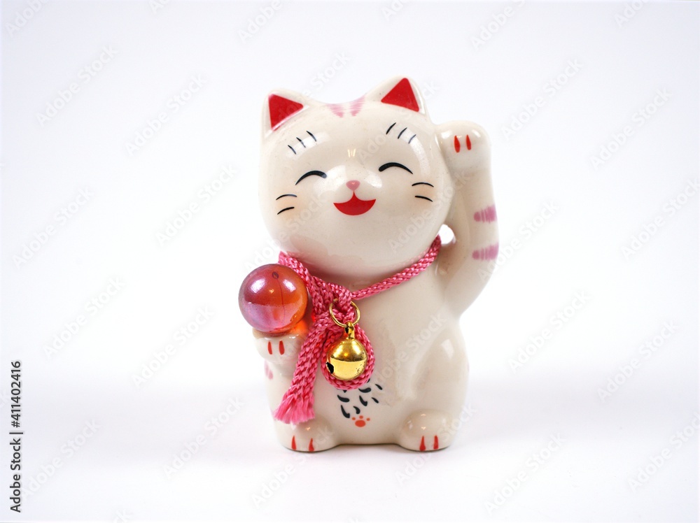 Lucky japanese cat souvenir ,maneki neko happy cat isolated on white background Lucky japanese cat souvenir ,maneki neko happy cat isolated on white background