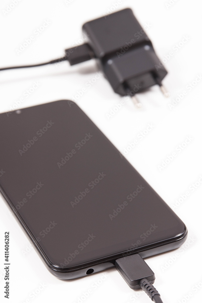Mobile phone with connected plug of charger. Smartphone charging Mobile phone with connected plug of charger. Smartphone charging
