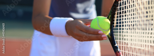 Close up of a tennis player hitting the ball with racket. © ty