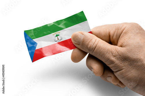 Hand holding a card with a national flag the Equatorial Guinea