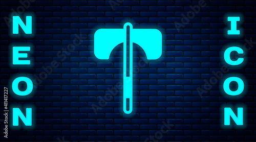 Glowing neon Medieval axe icon isolated on brick wall background. Battle axe, executioner axe. Medieval weapon. Vector.