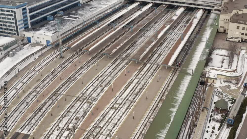 Aerial view of high-speed train. Electric locomotive with cars or railway wagon rides on railroad. Train Station Aerial Drone. highspeed train aerial top down view Aerial view of high-speed train. Electric locomotive with cars or railway wagon rides on railroad. Train Station Aerial Drone. highspeed train aerial top down view