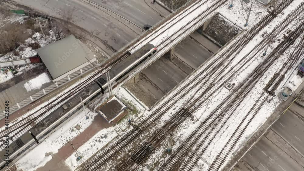 Aerial view of high-speed train. Electric locomotive with cars or railway wagon rides on railroad. Train Station Aerial Drone. highspeed train aerial top down view Aerial view of high-speed train. Electric locomotive with cars or railway wagon rides on railroad. Train Station Aerial Drone. highspeed train aerial top down view