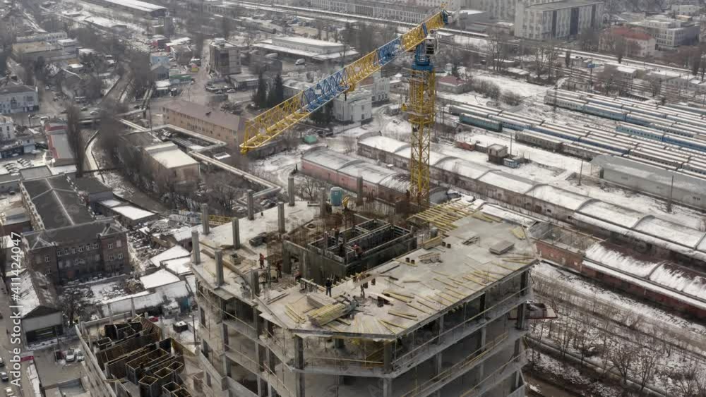 Building construction site. Сity development. Building machinery and high-rise houses in progress. Construction site with cranes - aerial drone view. Work of special equipment. Building construction site. Сity development. Building machinery and high-rise houses in progress. Construction site with cranes - aerial drone view. Work of special equipment.