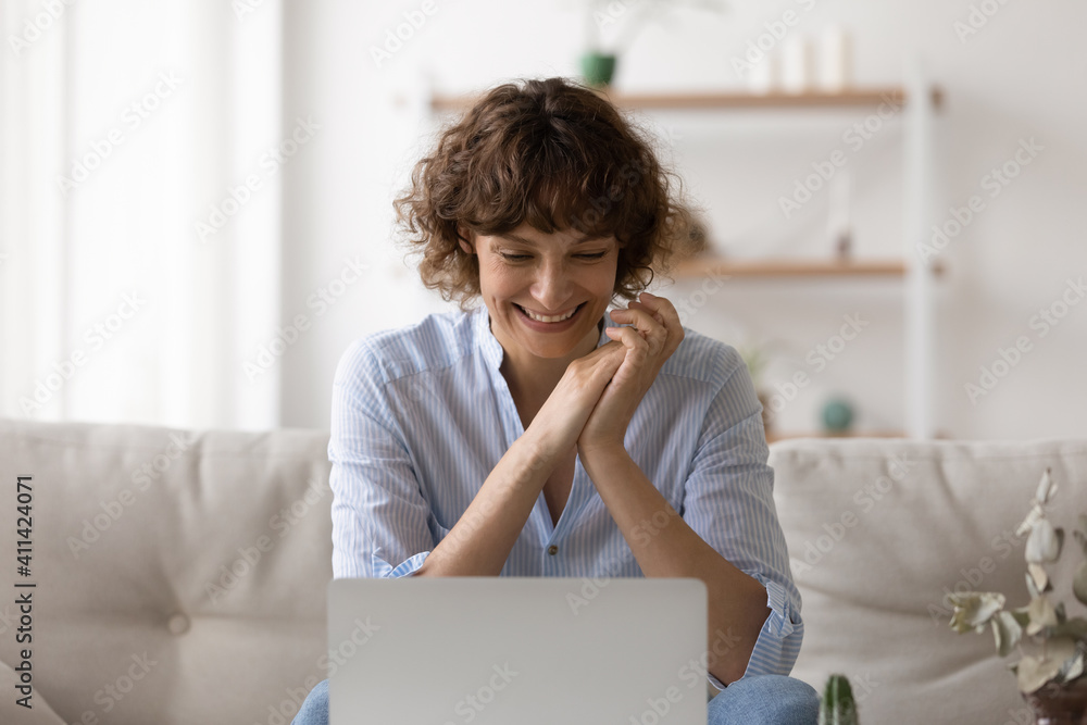 Smiling young woman relax in living room talk on video call on computer gadget. Happy Caucasian female speak on webcam digital conference, work distant on computer at home office. Technology concept. Smiling young woman relax in living room talk on video call on computer gadget. Happy Caucasian female speak on webcam digital conference, work distant on computer at home office. Technology concept.