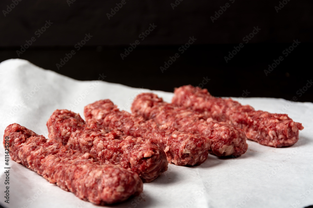 minced meat on white paper on dark background minced meat on white paper on dark background