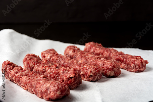 minced meat on white paper on dark background