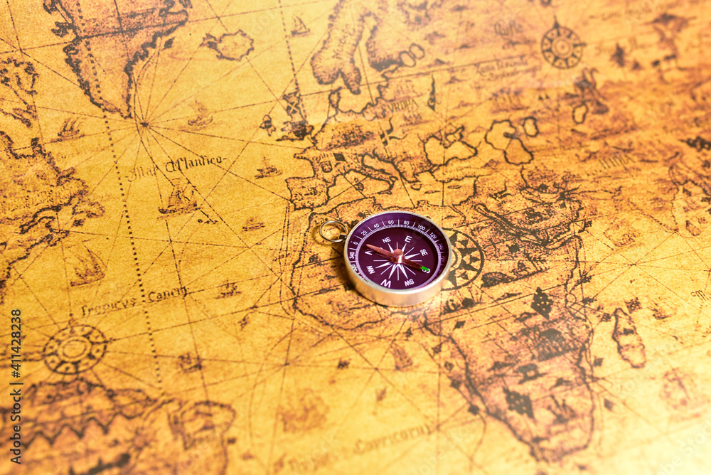Compass on map. Tourist compass for orientation on the terrain. Magnetic declination сalculator. Historical explorer help. Map reading and land navigation concept. Orient on maps Compass on map. Tourist compass for orientation on the terrain. Magnetic declination сalculator. Historical explorer help. Map reading and land navigation concept. Orient on maps