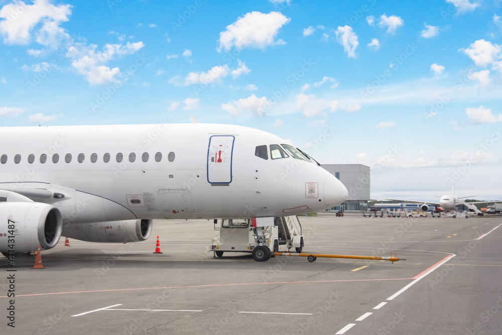 Parked aircraft on an airport in the afternoon in good weather. Parked aircraft on an airport in the afternoon in good weather.