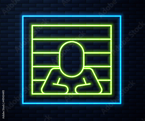 Glowing neon line Prisoner icon isolated on brick wall background. Vector.