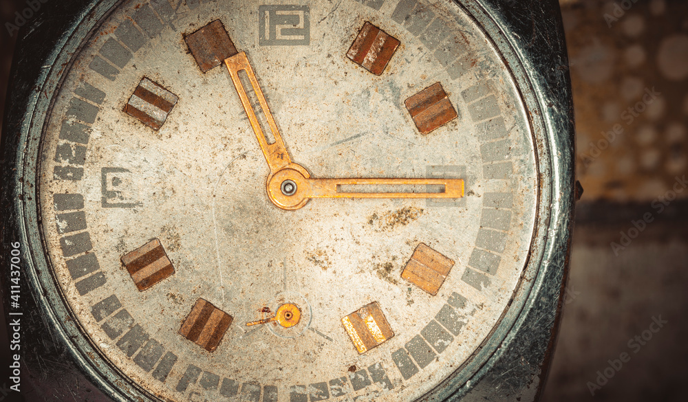 Vintage grunge background of an old clock. Abstract texture covered with dust, dirt, scratches. Macro photography in light tinted