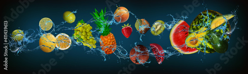 Fototapeta Naklejka Na Ścianę i Meble -  Panorama with fruits in water - lime, lemon, grapes, pineapple, pear, kiwi, pomegranate, watermelon, avocado create a balance of vitamins and minerals in the human body