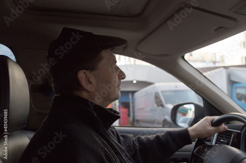 A man drives a car around the city. © indigolotos