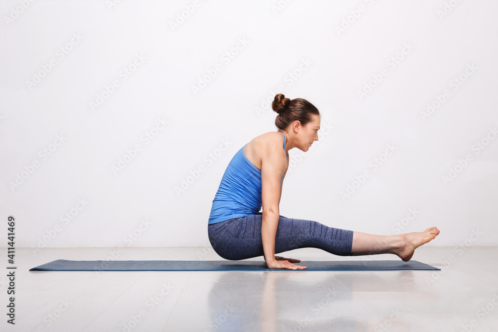 Fototapeta premium Woman doing Hatha asana Utpluti dandasana - lifted stuff pose