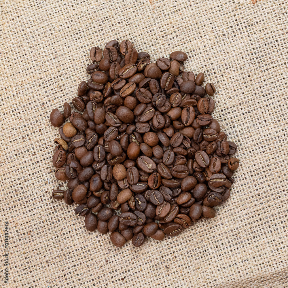 Roasted coffee beans on the fabric of the bag Roasted coffee beans on the fabric of the bag
