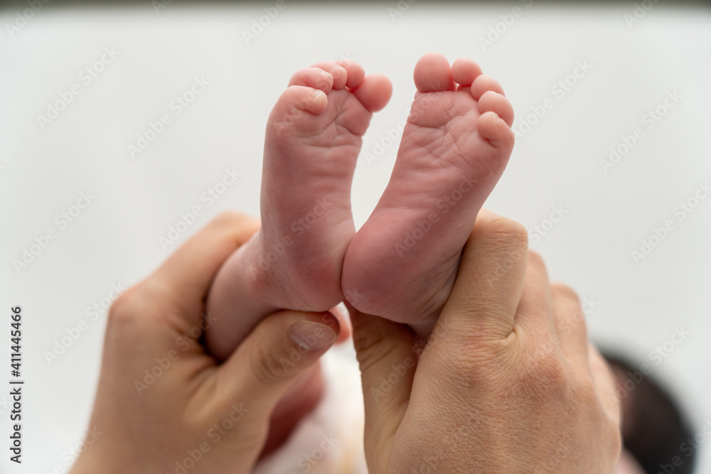 A baby's foot being held in a mother's hand_10