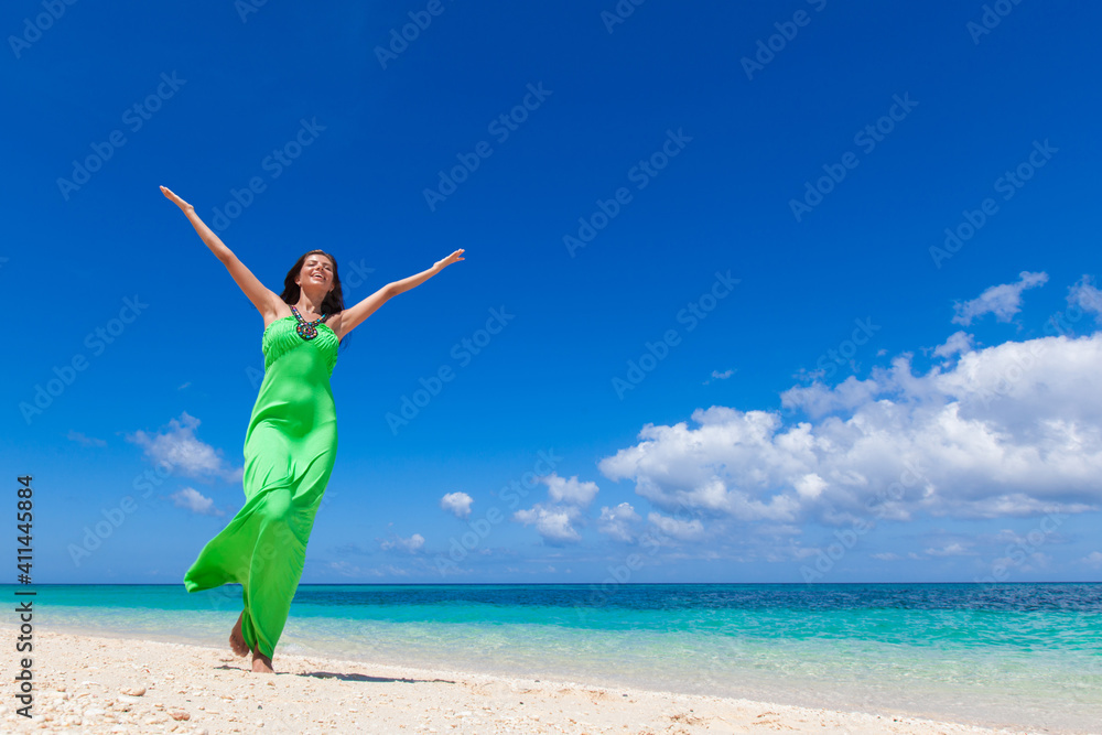 Woman in green dress on beach Woman in green dress on beach
