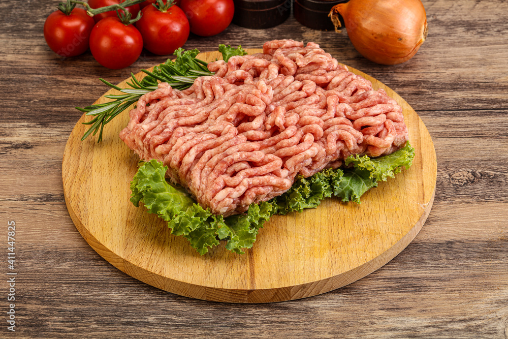 Raw pork minced meat over board Raw pork minced meat over board