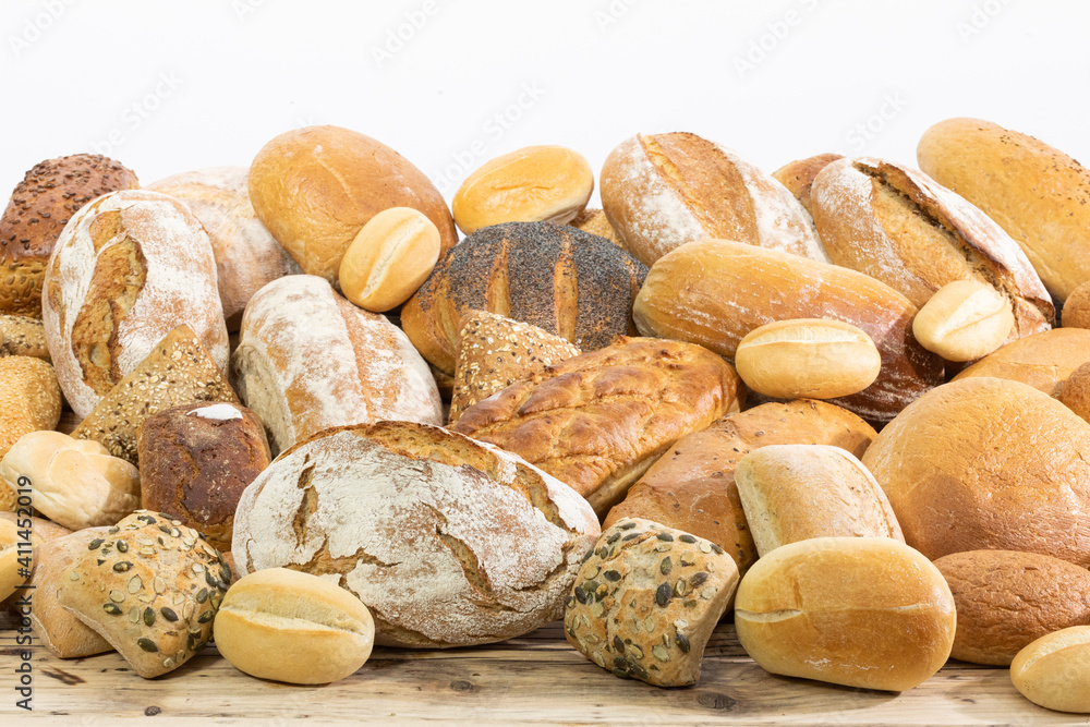 Many kinds and kinds of bread collected in one place on a wooden old shop counter as a decoration for a traditional bakery. White background from the top for self-completion. Many kinds and kinds of bread collected in one place on a wooden old shop counter as a decoration for a traditional bakery. White background from the top for self-completion.