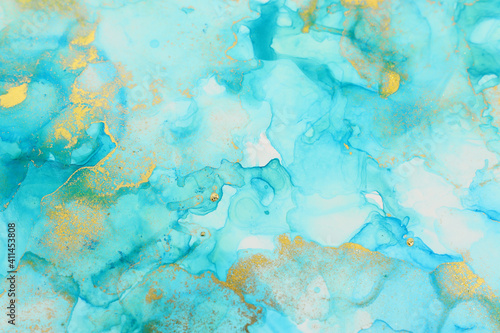 art photography of abstract fluid art painting with alcohol ink, blue and gold colors