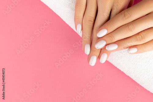 Womans hands with trendy white french manicure photo